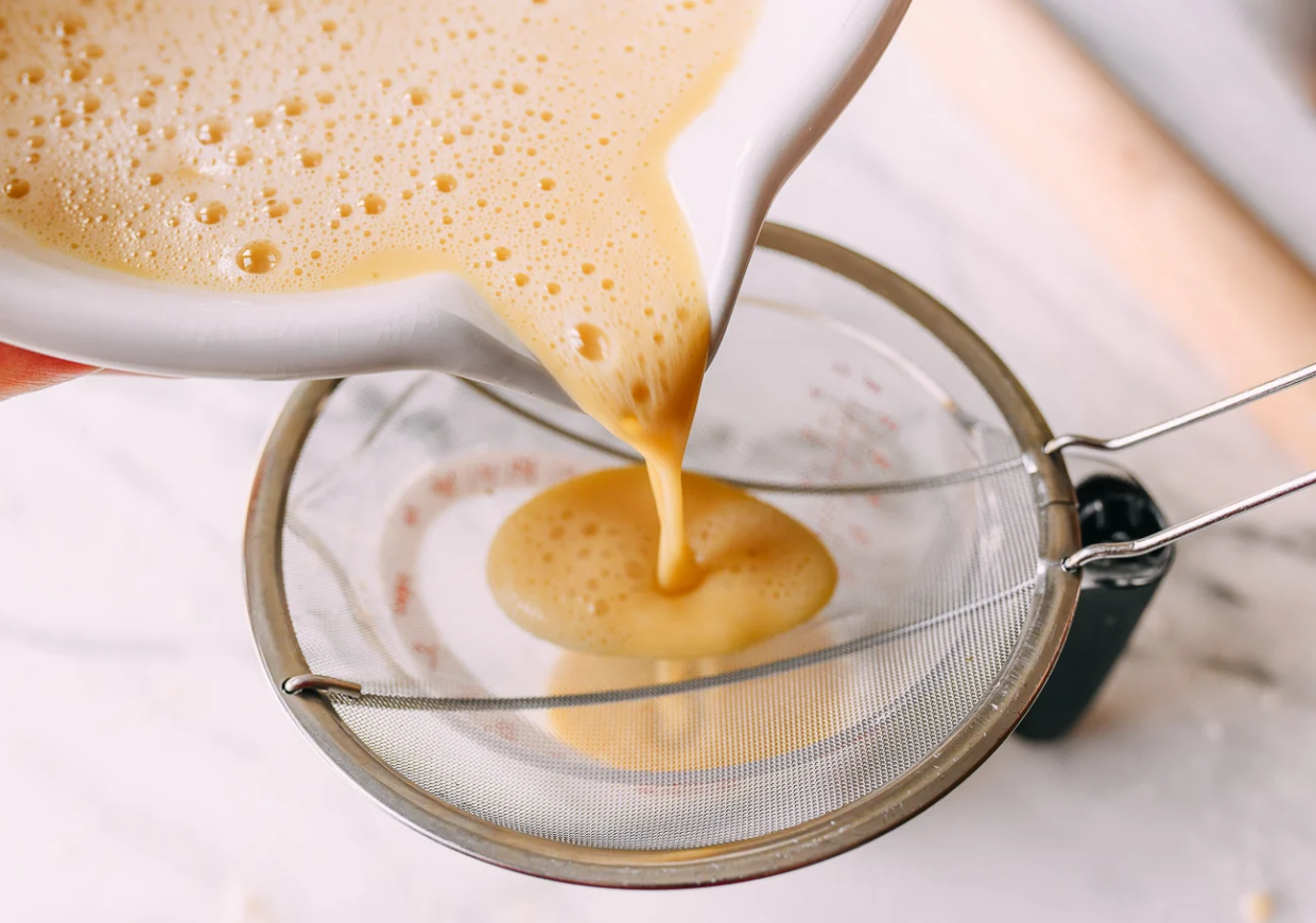 Straining egg custard mixture